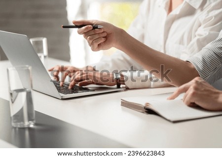 Business people taking meeting minutes Royalty-Free Stock Photo #2396623843