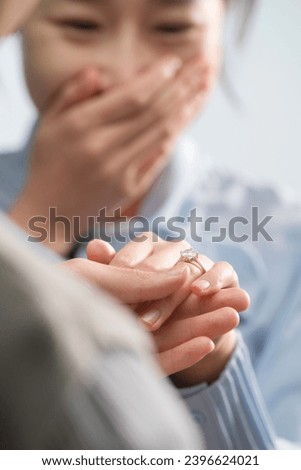 A man puts a ring on a woman