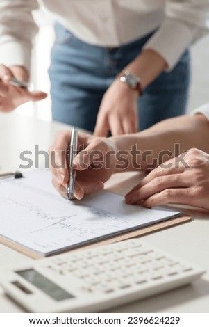 Business people study work with datasheets Royalty-Free Stock Photo #2396624229