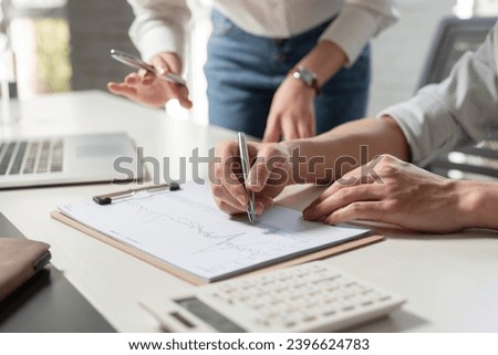 Business people study work with datasheets Royalty-Free Stock Photo #2396624783