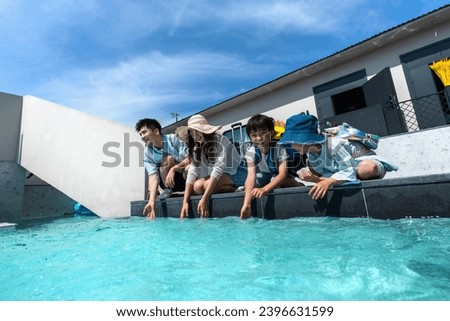 Happy families in a swimming pool of a home stay facility