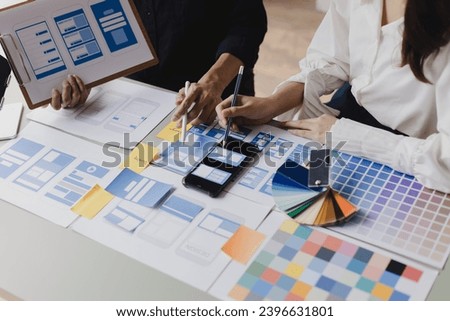 Close up business hands working with UX developer and UI designer at table in modern office. Creative and development agency concept.