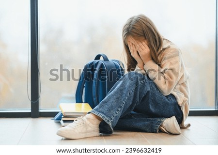 Bullying, discrimination or stress concept. Sad teenager crying in school. Royalty-Free Stock Photo #2396632419