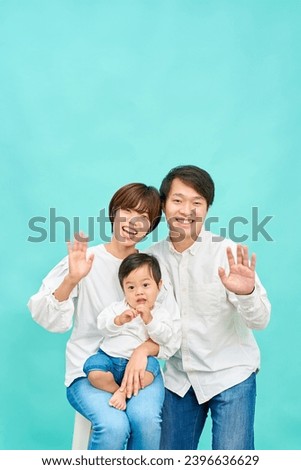 A smiling family waving their hands friendly