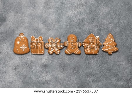 Border of Christmas gingerbread cookies on a gray grunge background. Top view, flat lay, copy space.