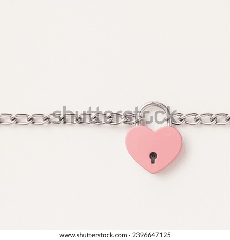Composition Valentines day background with pink heart is tied with a chain and a padlock . Minimal concept of Valentine's Day or love. Creative art, minimal aesthetics.Top view. Flat lay Royalty-Free Stock Photo #2396647125