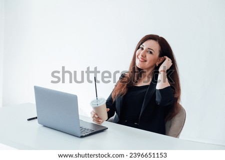 Business woman working on laptop online and smiling