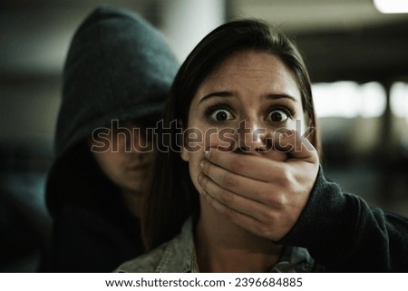 No, this cant be happening. A terrified young woman held captive by a man with his hand over her mouth. Royalty-Free Stock Photo #2396684885