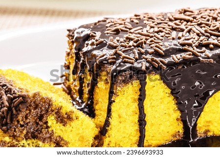 sliced ​​carrot cake with chocolate sprinkles, creamy icing running down the cake, traditional sweet from Brazil