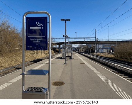 SBB Swiss Federal Railways smoking area sign. german text translation: smoking area maximum two meters. Thank you. Focus on the info sign