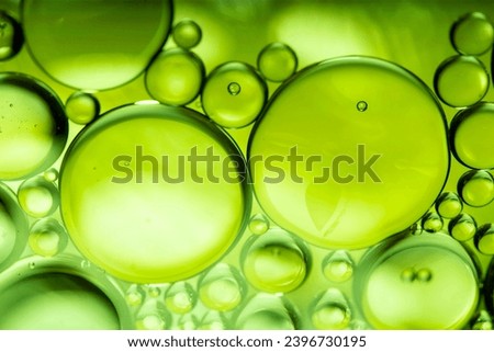 lemon drops of oil or serum texture background. Abstract lemon fluid with bubbles Royalty-Free Stock Photo #2396730195