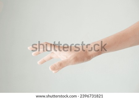 A male hand reaches for something or points to something isolated on a white background. Isolated hand reaching out. Photo for body part hand. Royalty-Free Stock Photo #2396731821