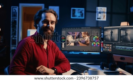 Portrait of happy videographer using professional software to create visual effects for video projects. Smiling expert using post production techniques to edit raw clips footage, zoom in shot