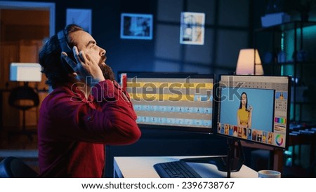 Photo editor editing images in post production company using graphic tablet, enjoying music. Photographer fixing overexposed pictures with touchscreen device, listening songs through headphones