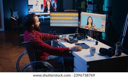Photo editor in wheelchair color correcting photographs in personal studio. Freelancer with locomotor disability selecting best pictures for editorial content using retouching software