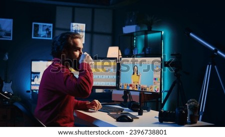 Photo editor editing images in post production company using retouching software. Photographer fixing overexposed pictures, adjusting white balance slider while drinking coffee
