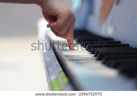 A child's hand playing piano