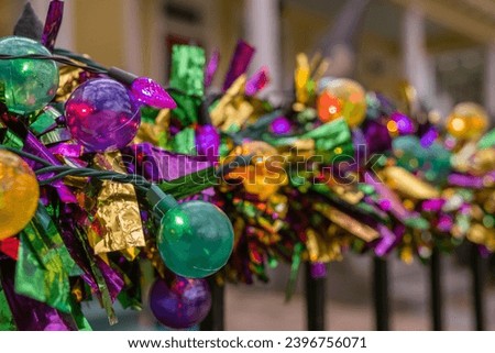 Mardi Gras decorations in the French Quarter in New Orleans in the colors of purple, gold and green.