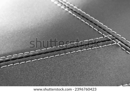 An interior view of a leather automobile seat. macro picture. ,natural suede leather background with an abstract texture
