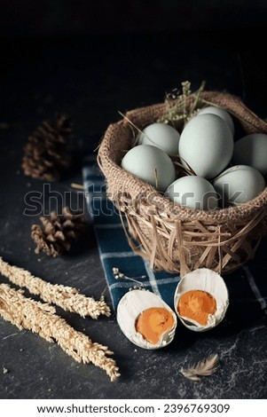 salted eggs, duck eggs in the bamboo basket and sackcloth with dark background. split salted eggs.