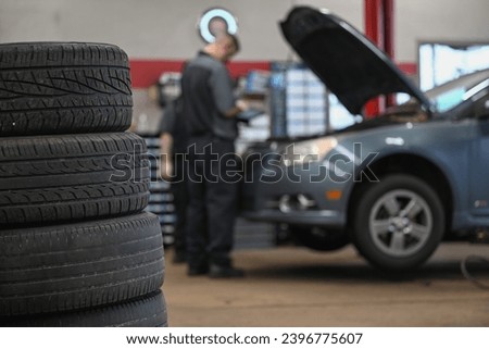 auto mechanic working in auto repair shop Royalty-Free Stock Photo #2396775607
