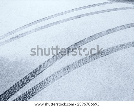 snow-covered road with fresh tire prints. winter urban background.