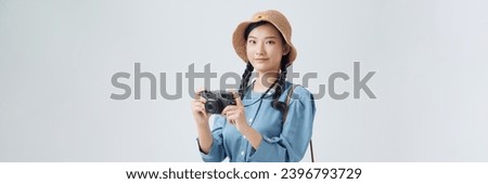 Full isolated studio picture from a young and beautiful woman with camera