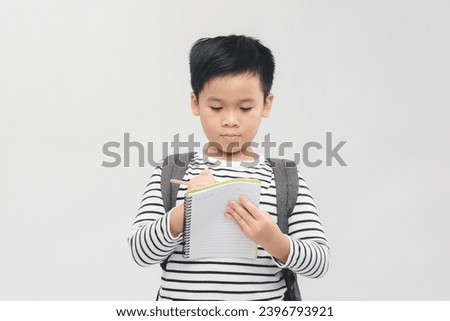 Banner of happy smiling 10 year-old asian boy with backpack and books ready to go to school Royalty-Free Stock Photo #2396793921