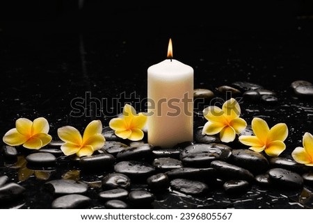 .spa still life with Spa stone and yellow frangipani, flowers  with candle  Royalty-Free Stock Photo #2396805567