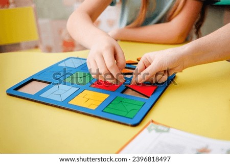 Study of color and shape. Matching game. Montessori methodology tool for concentration, speech therapy and fine motor skills. Royalty-Free Stock Photo #2396818497