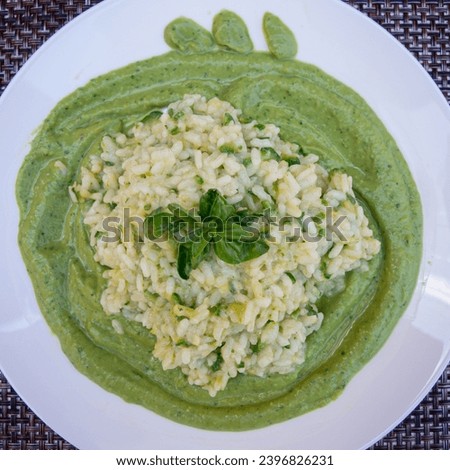 A top view photograph capturing a plate of creamy asparagus risotto, highlighting its vibrant colors and appetizing presentation