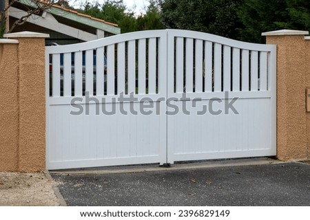 Aluminum white round metal double gate of suburb house Royalty-Free Stock Photo #2396829149