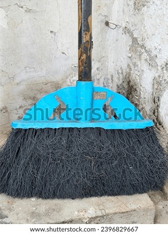 black fiber broom in the corner of the house
