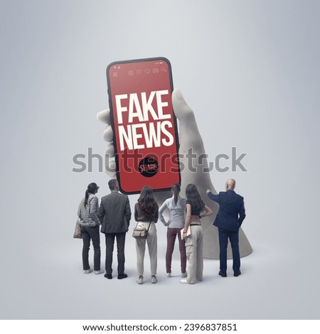 Group of diverse people standing in front of a huge smartphone and following fake news online, they are staring at the device screen Royalty-Free Stock Photo #2396837851