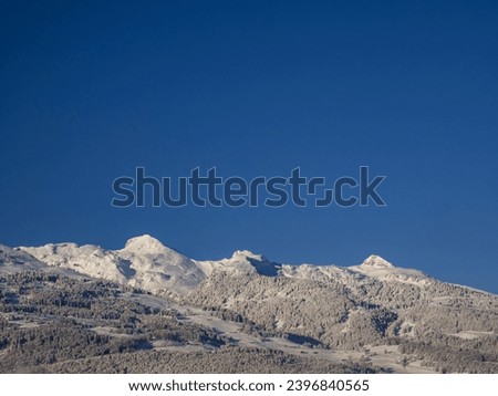 Beautiful wintry mountain range against blue sky