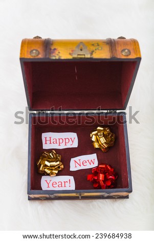 Abstract creative concept greeting card with text message Happy New Year on the paper in trunk with fir and pine cones, needles, bow, ribbon, christmas ball, toys, beads, tree,  isolated on background