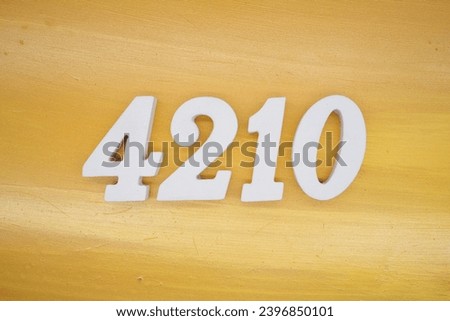 The golden yellow painted wood panel for the background, number 4210, is made from white painted wood.