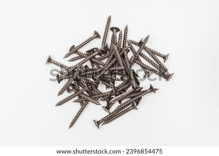screws on a white background. photo of self-tapping screws for the catalog on a light background. set of bolts for construction work