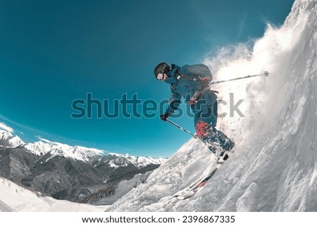 Freeride professional skier jumps at off-piste ski slope. Extreme sports at ski resort Royalty-Free Stock Photo #2396867335