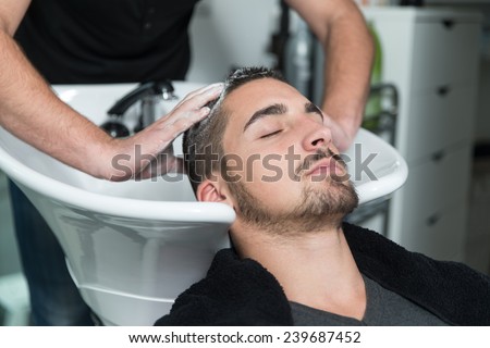 Hairstylist Hairdresser Washing Customer Hair - Young Man Relaxing In Hairdressing Beauty Salon Royalty-Free Stock Photo #239687452