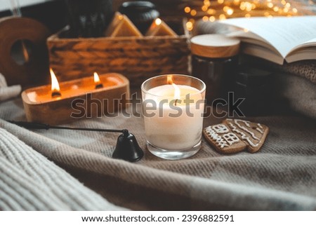 Burning candle and gingerbread in a festive cozy interior.