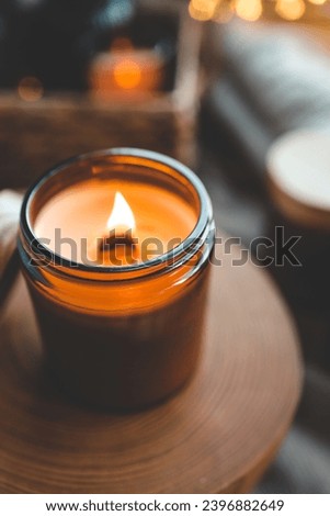 Burning candle in a festive cozy interior.