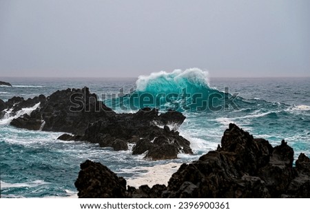 Sea waves at the rocks. Waves crashing on rocks. Sea waves crashing on sea rocks.  Sea waves crashing