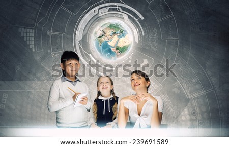 Young teacher and her pupils examining Earth planet. Elements of this image are furnished by NASA