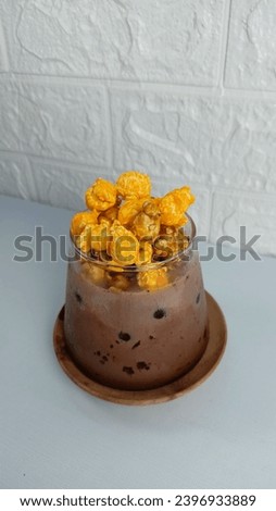 Chocolate milk with choco cheese popcorn on the top. 