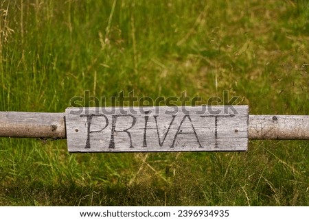 German sign saying "privat" (private) on a fence in a farm