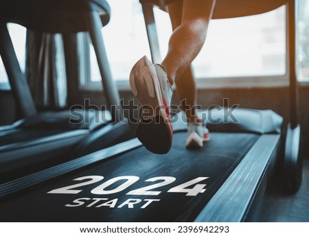 Happy new year 2024,2024 symbolizes the start of the new year. Close up of feet, sportsman runner running on treadmill in fitness club. Cardio workout. Healthy lifestyle, guy training in gym. Royalty-Free Stock Photo #2396942293