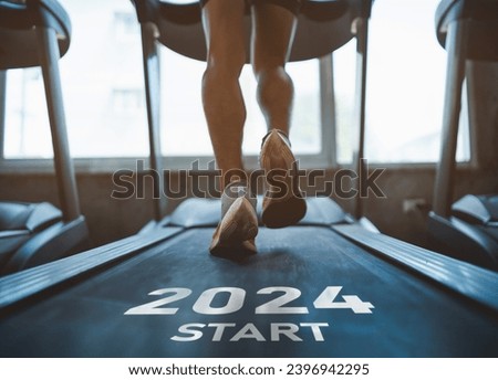Happy new year 2024,2024 symbolizes the start of the new year. Close up of feet, sportsman runner running on treadmill in fitness club. Cardio workout. Healthy lifestyle, guy training in gym. Royalty-Free Stock Photo #2396942295