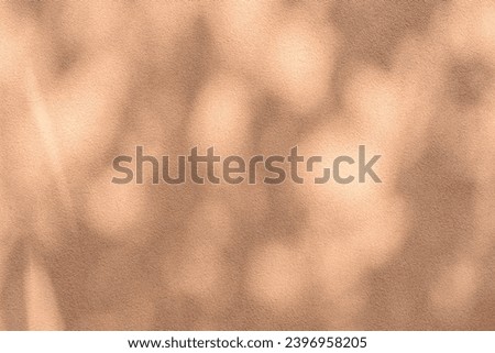 Abstract leaves shadow background with light bokeh toned in trendy pantone Peach Fuzz color of Year 2024, Abstract shadow background of natural leaves tree branch falling on wall
