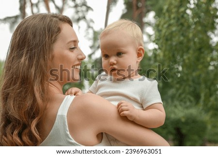 Mother with her cute baby spending time together outdoors